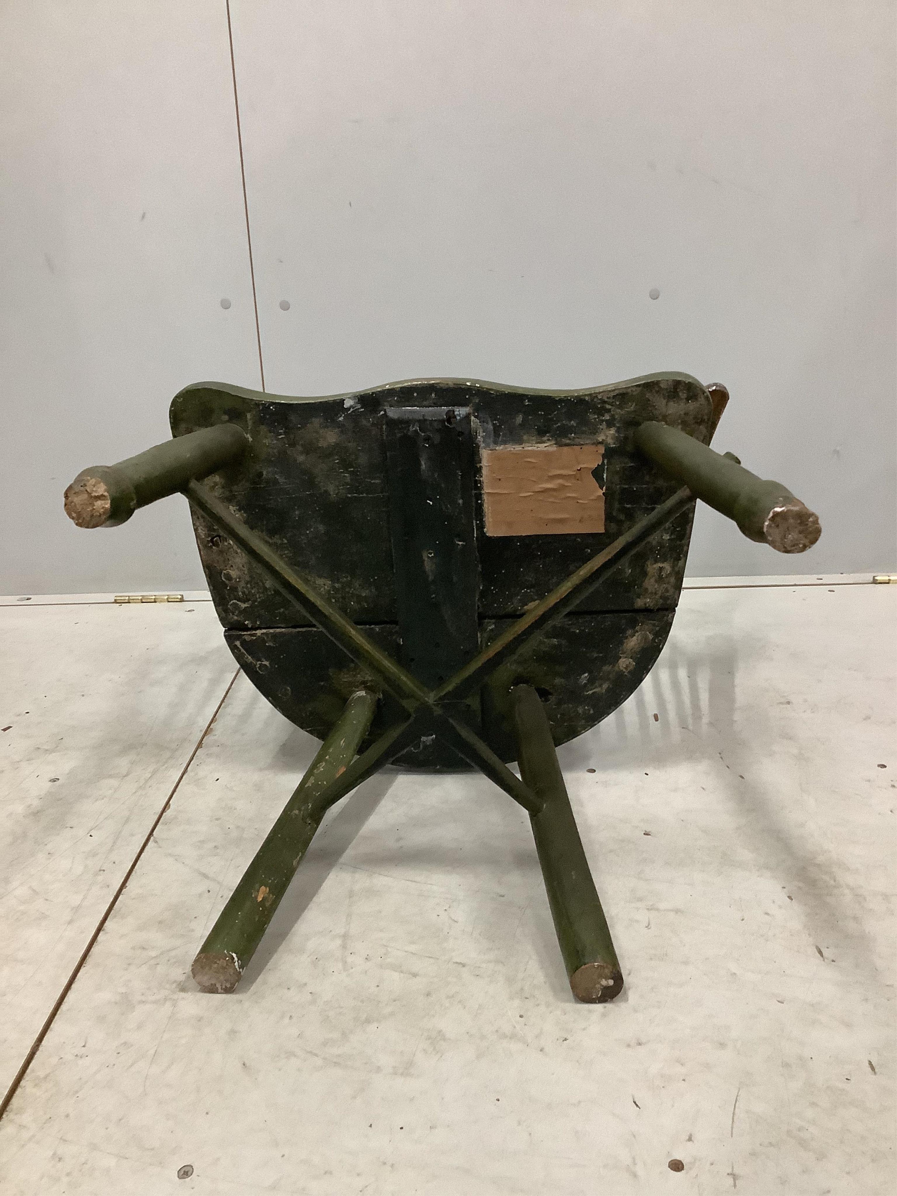 An early 19th century primitive arched stick back elbow chair, width 66cm, depth 43cm, height 95cm. Condition - poor to fair